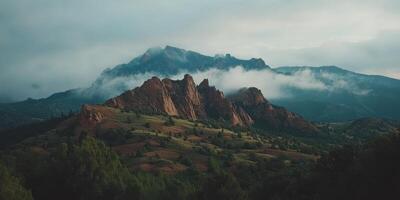 Jagged mountain peaks emerge through misty clouds photo