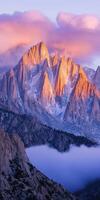 Vivid sunset colors illuminate jagged mountain peaks photo