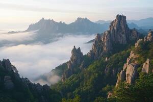 Jagged mountain peaks rise above a misty valley photo