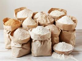 Various types of flour in paper bags neatly arranged on a table photo