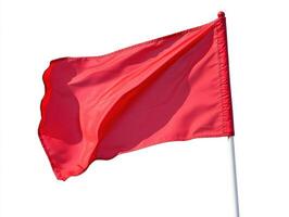 Red flag fluttering in the wind against a clear sky photo