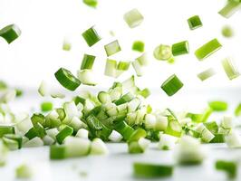 Chopped green onions falling in the kitchen during preparation photo