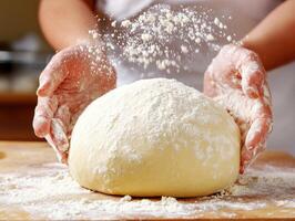 Baker preparing dough with flour in a kitchen setting photo