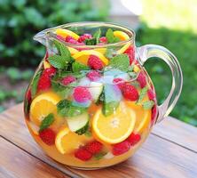 Refreshing fruit punch with berries and citrus on a sunny day photo
