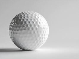 Golf ball resting on a smooth surface with soft lighting photo