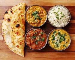 Traditional Indian meal served with naan, curry, and rice photo