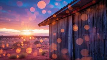 Captivating sunset over a rustic wooden building in the desert landscape with vibrant colors and soft bokeh effects photo