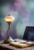 Elegant lamp casts warm light near an open notebook and laptop on a rustic table photo