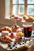 Delicious pastries and refreshing iced coffee on a rustic table in a sunlit cafe setting photo