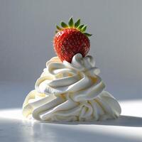 Delicious whipped cream topped with fresh strawberry on a sunny surface photo