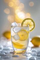 Refreshing lemon drink in a glass with ice and lemon slices against a softly illuminated background photo