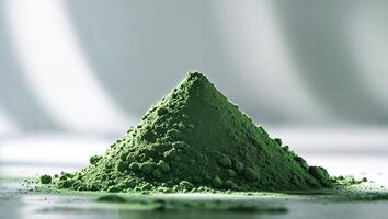 Green powder is showcased with delicate texture on a clean surface, illustrating its fine consistency and natural color photo