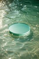 Circular glass object floats peacefully on the surface of a tranquil swimming pool in bright sunlight photo