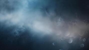 Dark blue abstract background with soft clouds and blurred light effects creating a mystical atmosphere photo