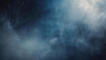 Atmospheric blue mist with swirling clouds in a dark space, creating a mystical and serene ambience photo