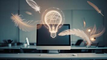 Creative ideas emerge from workspace with glowing light bulb above computer and drifting feathers photo