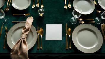 Elegant dining table setting in a formal atmosphere with gold cutlery and white plates photo