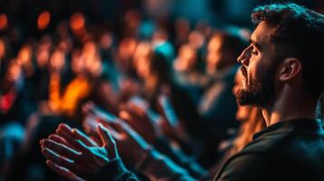 Audience enthusiastically applauding during a live performance in a dimly lit venue photo