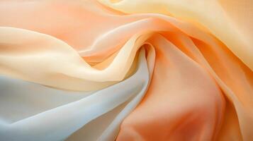 Soft flowing fabric showcasing delicate hues of peach, cream, and light blue with intricate texture photo