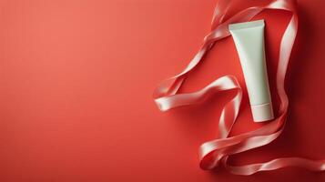 Skincare product displayed with pink ribbon on a vibrant red background photo