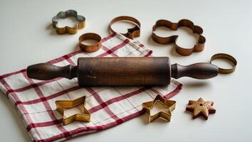 Baking tools arranged on a kitchen countertop with rolling pin and cookie cutters in creative layout photo