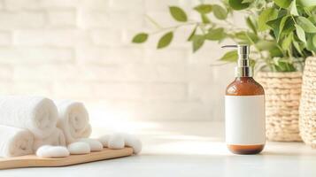 Spa setting with rolled towels, soothing stones, and a lotion bottle on a light countertop surrounded by greenery in a tranquil atmosphere photo