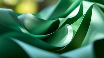 Colorful green waves of smooth material create a vibrant abstract texture in natural light photo