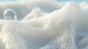 Foam on the surface of ocean waves creates a soft and tranquil atmosphere at the beach during a sunny afternoon photo