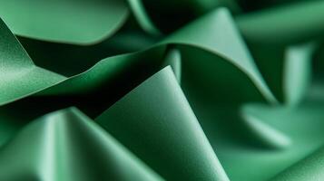 Textured green paper folds creating an abstract pattern in a vibrant display of color and form photo