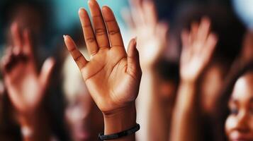 People participating in an interactive event by raising hands for questions and engagement during a lively discussion photo