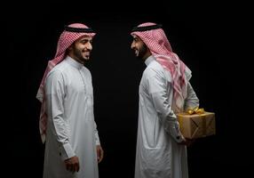 Smiling Arab Men Exchange Gift Black Background photo