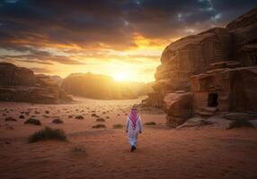 Man Walking in Desert Landscape at Sunset with Sandstone Rock Formations photo