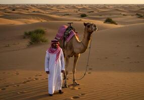 Man and Camel Walking in the Desert Sands at Sunset photo