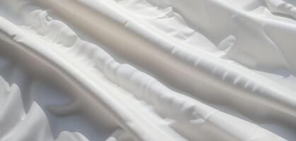 Elegant white fabric with soft folds and subtle shadows creates a smooth texture photo