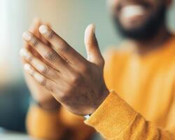 Close up of hands clapping, expressing appreciation and joy in warm setting. hands are well groomed, showcasing sense of professionalism and engagement photo
