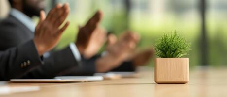 Applauding team members in modern boardroom with decorative plant. atmosphere is positive and collaborative, showcasing teamwork and appreciation photo