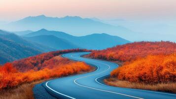 Winding road through vibrant autumn landscape with mountains in background, showcasing beautiful orange foliage and serene atmosphere photo