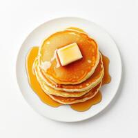 Fluffy pancakes stacked high with pat of butter and drizzled with syrup create delicious breakfast treat. Perfect for any morning craving photo