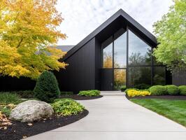 stunning mid century modern house featuring floor to ceiling windows, surrounded by vibrant autumn foliage and lush landscaping, creating serene and inviting atmosphere photo
