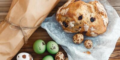 Beautiful Easter bread, quail eggs, and catkins arranged on a rustic table setting photo