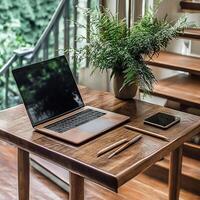 Modern workspace with laptop and greenery by stairs in cozy indoor setting photo