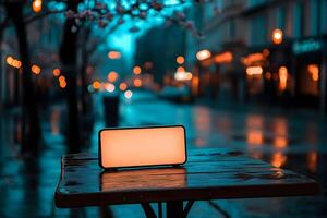 Empty illuminated sign on wet table at night, city street background. photo