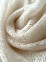 Swirled white knit fabric texture close-up photo