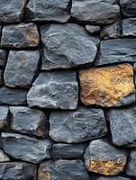 Dark gray stone wall with one gold stone, close-up, texture, background photo