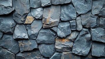 Dark gray uneven rock wall background, textured surface photo