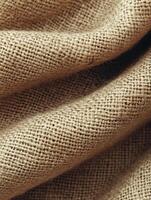 Folded burlap texture close-up, natural textile background photo