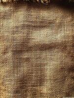 Close-up of rough woven fabric with fringe background is solid for rustic texture photo