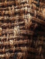 Close-up view of rough woven brown material. Use as a background or texture photo