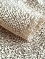 Close up of textured tan fabric with fringe for textile material photo