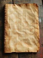 Old wrinkled notebook paper on a rough wood table, for notes photo